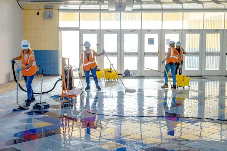 Cleanup crew extracting water from a flooded commercial tile floor