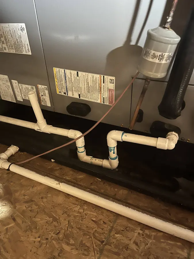 Attic air handler with its condensate drain lines over a wet platform