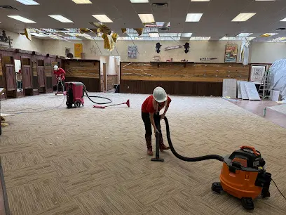 Crew extracting water from carpet tile in a large commercial space